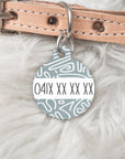 Back of dog tag with phone number