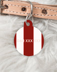 Dog collar with a red and white pet tag on a fluffy white background